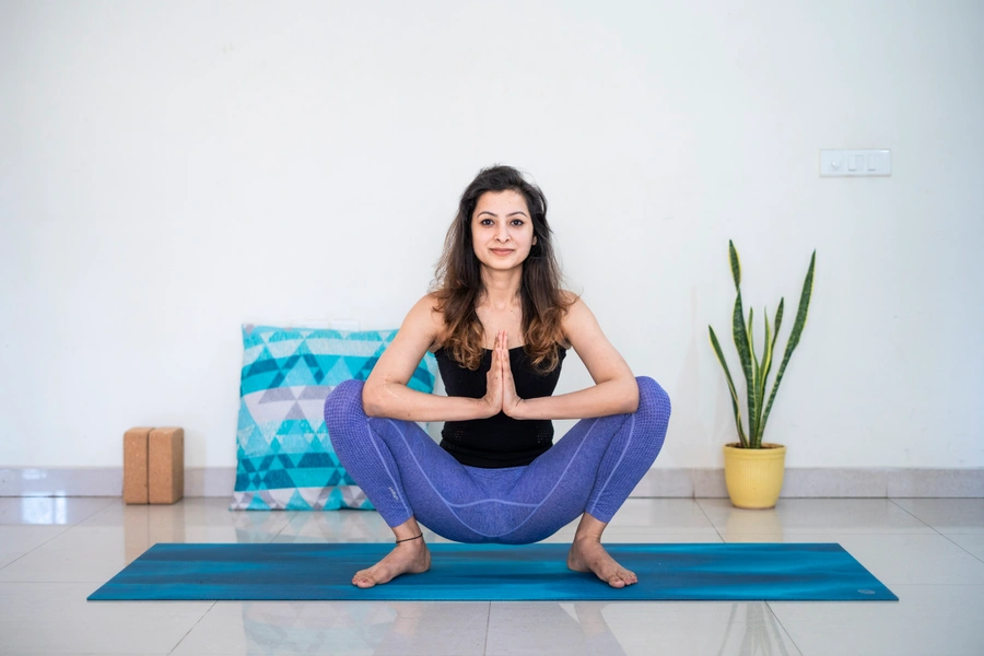 Woman doing butterfly pose yoga for PCOS management
