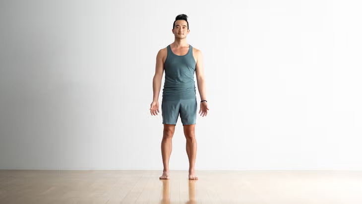 Person standing in Mountain Pose (Tadasana) with straight posture and calm breathing