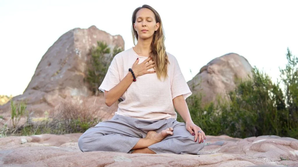 Is kundalini awakening dangerous concept showing energy rising through spine meditation pose